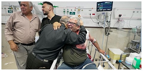 An injured journalist is being hugged by one of the colleagues of killed journalist Shireen Abu Akleh, a journalist for the Al-Jazeera network, in the Hospital West Bank town of Jenin. (Photo | AP)