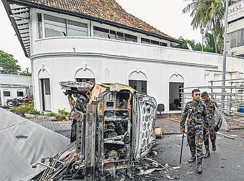 A burnt vehicle near PM’s house, a day after it was torched by protesters | AFP