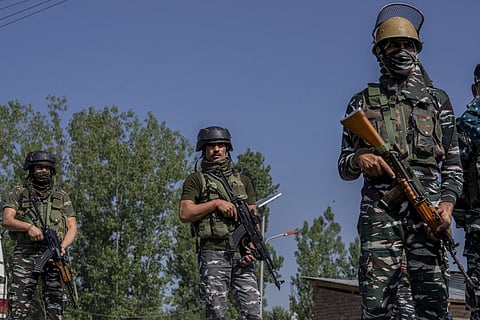 Paramilitary soldiers stand guard near the site where a policeman was shot at in Srinagar on May 7, 2022. (File | AP)