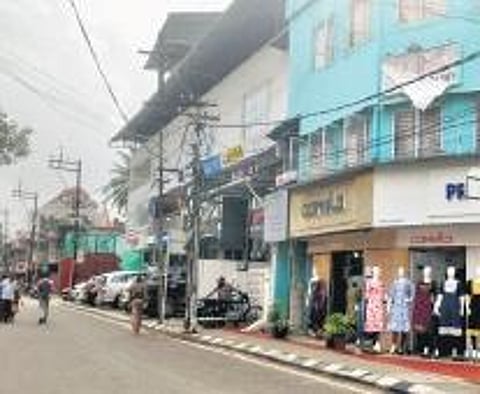 The present Press Club Road dotted with textile shops. (Inside) An advertisement of Basheer’s Book Stall