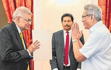 Ranil Wickremesinghe (L) being greeted by Gotabaya Rajapaksa before the swearing-in ceremony in Colombo | AFP