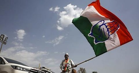 A Congress worker with party flag during the 'Nav Sankalp Shivir' at Udaipur in Rajasthan, on Friday. (Photo | Shekhar Yadav/EPS)