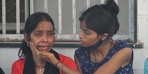 Relatives react as they wait for reports on missing persons after a massive fire at an office building near the Mundka Metro Station, outside Sanjay Gandhi Memorial Hospital in New Delhi. (Photo | PTI