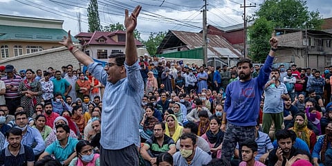 Kashmiri Pandits block a road during a protest against the killing of Rahul Bhat, on the outskirts of Srinagar. (Photo | AP)