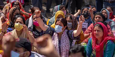 Kashmiri Pandits block a road during a protest against the killing of Rahul Bhat on the outskirts of Srinagar. (Photo | AP)