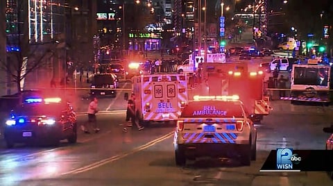 This photo taken from video provided by WISN 12 News shows police responding to the scene of a shooting at Water Street and Juneau Avenue in Milwaukee. ( Photo | AP)