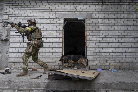 A Ukrainian serviceman patrols during a reconnaissance mission in a recently retaken village on the outskirts of Kharkiv, east Ukraine, Saturday, May 14, 2022.(Photo| AP)