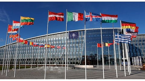 Flags flutter in the wind outside NATO headquarters in Brussels.