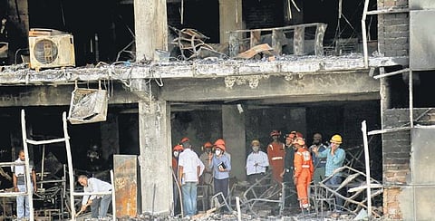 Officials investigate the site of Mundka fire on Sunday | pti