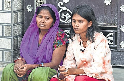 Family members of the missing people wait outside the gutted building in Mundka on Sunday | parveen negi