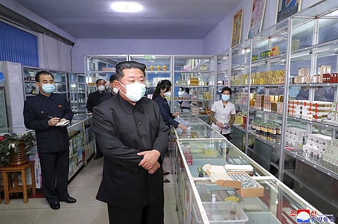 North Korean leader Kim Jong Un, center, visits a pharmacy in Pyongyang, North Korea on May 15, 2022.(Photo | AP)
