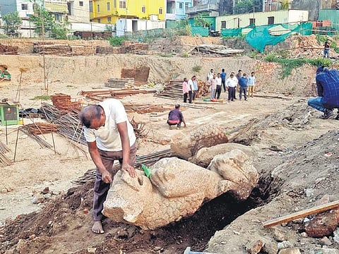 A worker cleaning the broken lion sculpture found in the prohibited area of Sri Jagannath temple in Puri on Tuesday | express