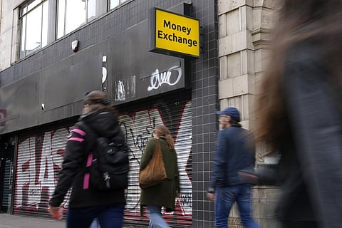 Shoppers pass a closed money exchange retail unit on Oxford Street in London. (Photo | AP)