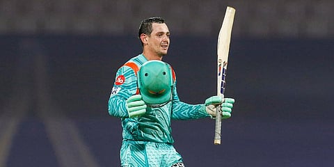 Quinton De Kock raises his bat to celebrate his century during cricket match between Lucknow Super Giants and Kolkata Knight Riders, at DY Patil Stadium in Mumbai. (Photo | PTI)