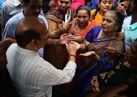 Chief Minister Basavaraj Bommai consoles residents during his city rounds on Thursday at Mahalakshmi Layout where he was inspecting rain damages (Photo | Shriram BN)