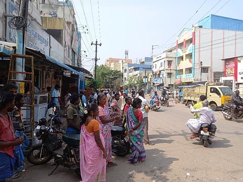 Unmindful of the heat, a few daily wage labourers wait near Thennur bridge in Tiruchy in the hope of being called for some work, on Sunday. (Photo | EPS)