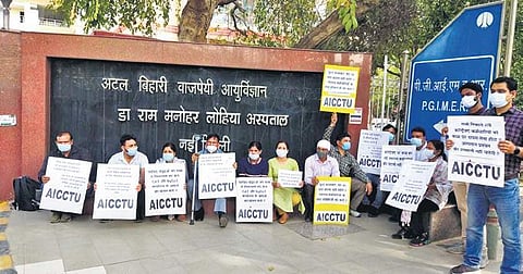 Ram Manohar Lohia Hospital contract employees stage a protest against their termination in New Delhi. (Photo| EPS)