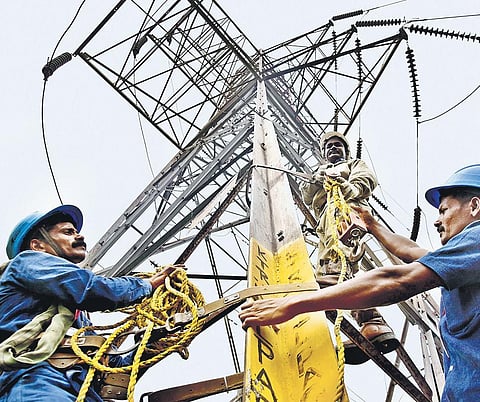 Tangedco staff working on an electricity tower. ( File Photo)