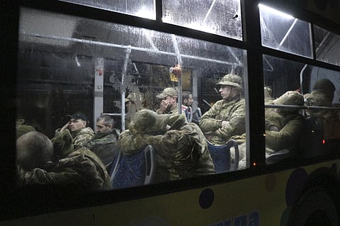 Ukrainian servicemen sit in a bus after leaving Mariupol's besieged Azovstal steel plant, near a penal colony, in Olyonivka, in territory under the government of the Donetsk People's Republic. (AP)