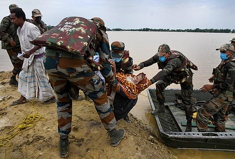 Army personnel evacuate flood-affected villagers during relief operations after heavy rainfall, in Hojai district, Thursday, May 19, 2022. (Photo | PTI)
