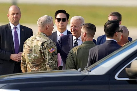 U.S. President Joe Biden, center, is greeted on his arrival at Osan Air Base in Pyeongtaek, South Korea, Friday, May 20, 2022.(Photo | AP)