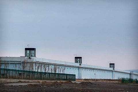 People stand in a guard tower on the perimeter wall of the Urumqi No. 3 Detention Center in Dabancheng in western China's Xinjiang Uyghur Autonomous Region. (Photo| AP)