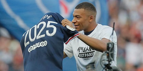 PSG's Kylian Mbappe waves a shirt to the crowd after it is announced that he has signed a three year extension to his deal to stay at the club. (Photo | AP)