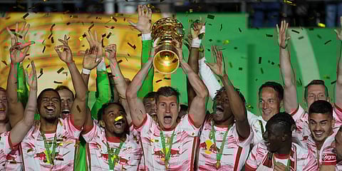 RB Leipzig players celebrate with the German Soccer Cup trophy at the end of the final match RB Leipzig won against SC Freiburg, and at the Olympic Stadium in Berlin, Germany. (Photo | AP)