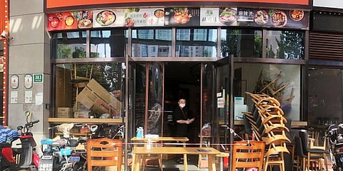 A restaurant closed to dine-in customers is open for takeout orders of ingredients for customers to self cook in Shanghai, China. (Photo | AP)