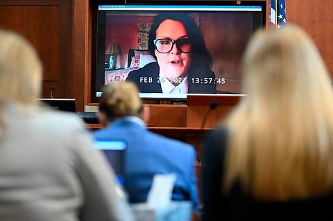 Jennifer Howell is seen on a screen testifying in a previously recorded video at the Fairfax County Circuit Courthouse in Fairfax. (Photo | AP)