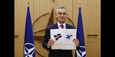 NATO Secretary-General Jens Stoltenberg displays documents as Sweden and Finland applied for membership in Brussels, Belgium, May 18, 2022. (Photo | AP)