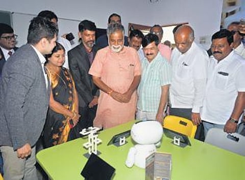 Education Minister BC Nagesh looks at robots used in a private school in Mysuru, on Tuesday