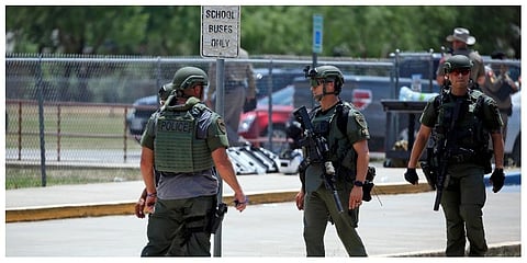 Law enforcement personnel stand outside Robb Elementary School following a shooting, Tuesday, May 24, 2022, in Uvalde, Texas. (Photo | AP)