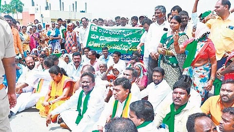 Farmers stage a sit-in protest on National Highway 163 between Arrepally and Naskal villages in Jangaon district on Wednesday