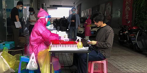 Residents line up to get a COVID-19 test in Shanghai. (Photo| AP)