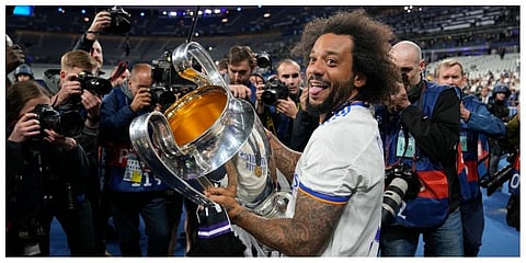Real Madrid's Marcelo holds the trophy while celebrating with team mates winning the Champions League final soccer match between Liverpool and Real Madrid on Sunday, May 29, 2022. (Photo | AP)