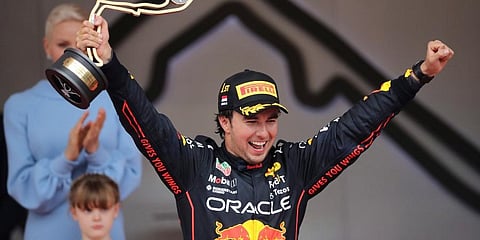 Red Bull driver Sergio Perez of Mexico celebrates on the podium after winning the Monaco Formula One Grand Prix, at the Monaco racetrack, in Monaco. (Photo | AP)