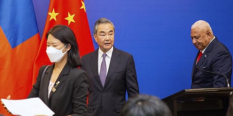 China's Foreign Minister Wang Yi, center, appears on stage at the Pacific Islands Foreign Ministers' meeting with Fiji's Prime Minister Frank Bainimarama, Monday, May 30, 2022.(Photo | AP)