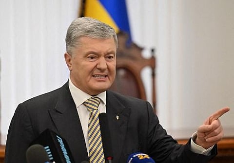 Ukraine's former leader Petro Poroshenko gestures as he speaks with journalists at the district court in Kyiv on January 28, 2022. (Photo | AFP)