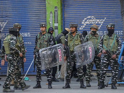 Indian paramilitary soldiers stand guard after clashes with people protesting against the sentencing of Kashmiri separatist leader Mohammed Yasin Malik. (Photo | AP)