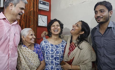 St Stephens alumnus Shruti Sharma, who topped the Civil Services 2021 Exam and secured AIR 1, with her family members at her residence. (Photo | EPS)