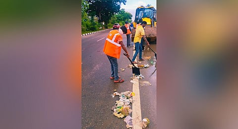 NHAI workers removing poultry waste from the NH-66 bypass at Muttathara.