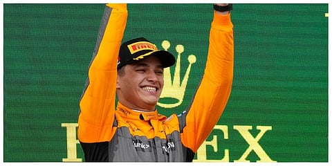 McLaren driver Lando Norris of Britain celebrates on the podium his third place at the Emilia Romagna Formula One Grand Prix, at the Enzo and Dino Ferrari racetrack, in Imola, Italy, Sunday, April 24.
