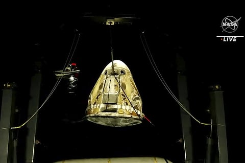 In this image made from video supplied by NASA, SpaceX Dragon space capsule is lifted out of the water after splashing down in the Gulf of Mexico. (Photo | AP)