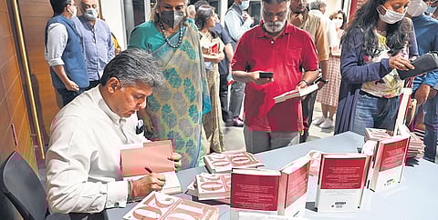 Former minister Manish Tewari signs a copy of his new book in Bengaluru on Thursday | Nagaraja Gadekal Nagaraja Gadekal