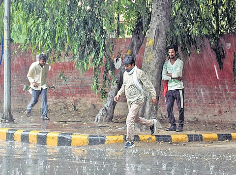 People come out in the rain at Barakhamba Road on Friday | Parveen negi