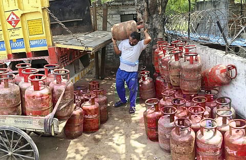 A man unloads LPG cylinders, as prices soar in New Delhi, Saturday, May 7, 2022. (Photo | PTI)