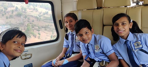 School children taking a ride in CM's chopper.