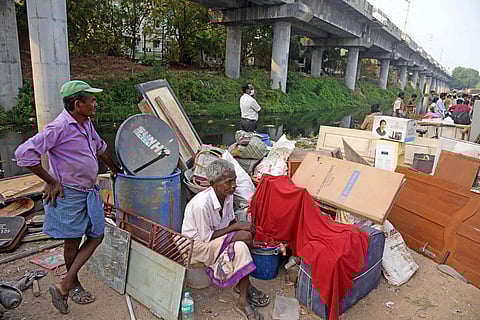 Residents evicted from Govindasamy Nagar on Greenways Road return to the railway station on Saturday due to bad condition of allotted houses. (Photo | R Satish Babu, EPS)