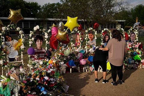 At a memorial for Robb Elementary School students and teachers who were killed in last week's school shooting in Uvalde, Texas. (Photo | AP)